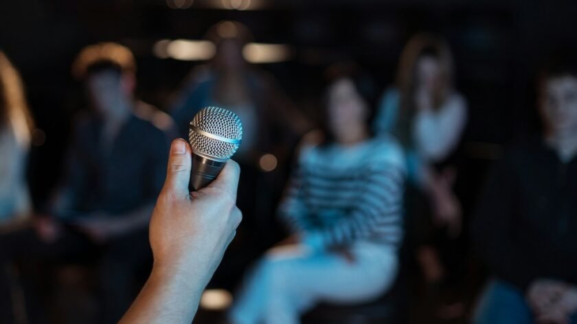 Software Engineer Holding Mic Facing the Crowd