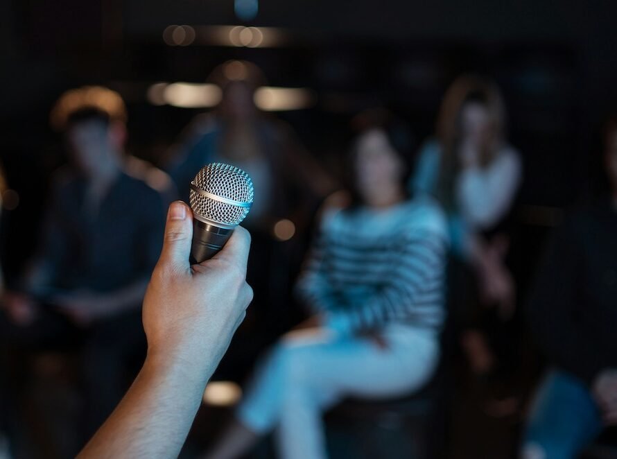 Software Engineer Holding Mic Facing the Crowd