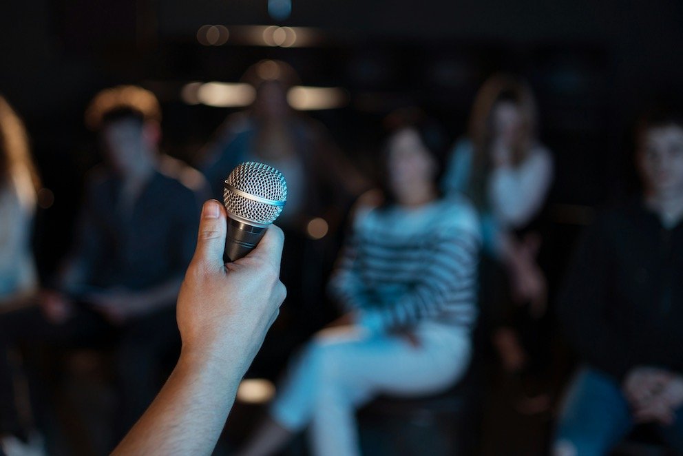 Mastering the Mic: How Public Speaking Catapults Your Software Engineer Career 4 Software Engineer Holding Mic Facing the Crowd