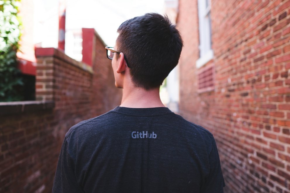 Most Effective Ways to Showcase Your Open-Source Contributions Effectively 2 Developer Wearing GitHub Shirt